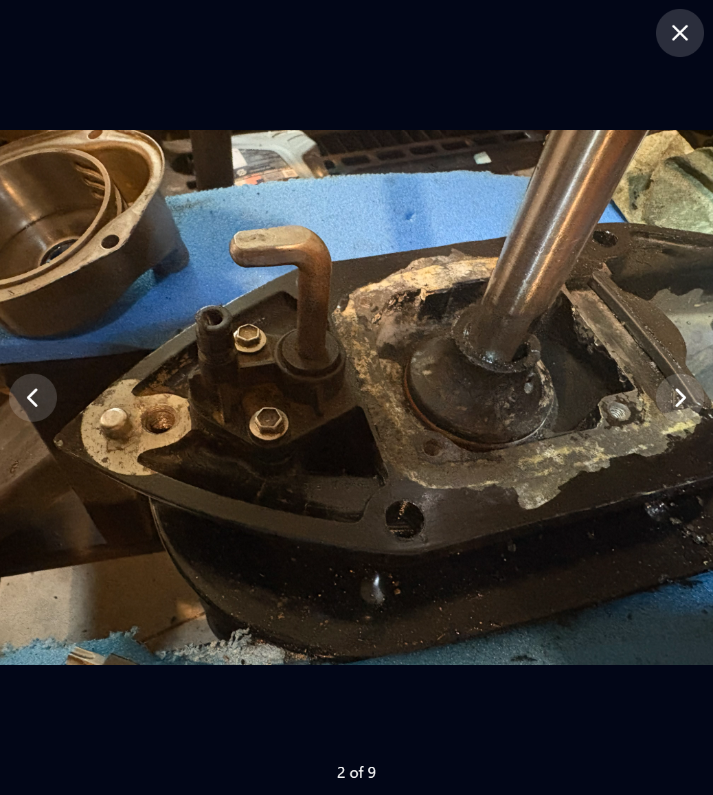 Full-screen project photo of the lower sterndrive after cleaning, labeled 2 of 9.