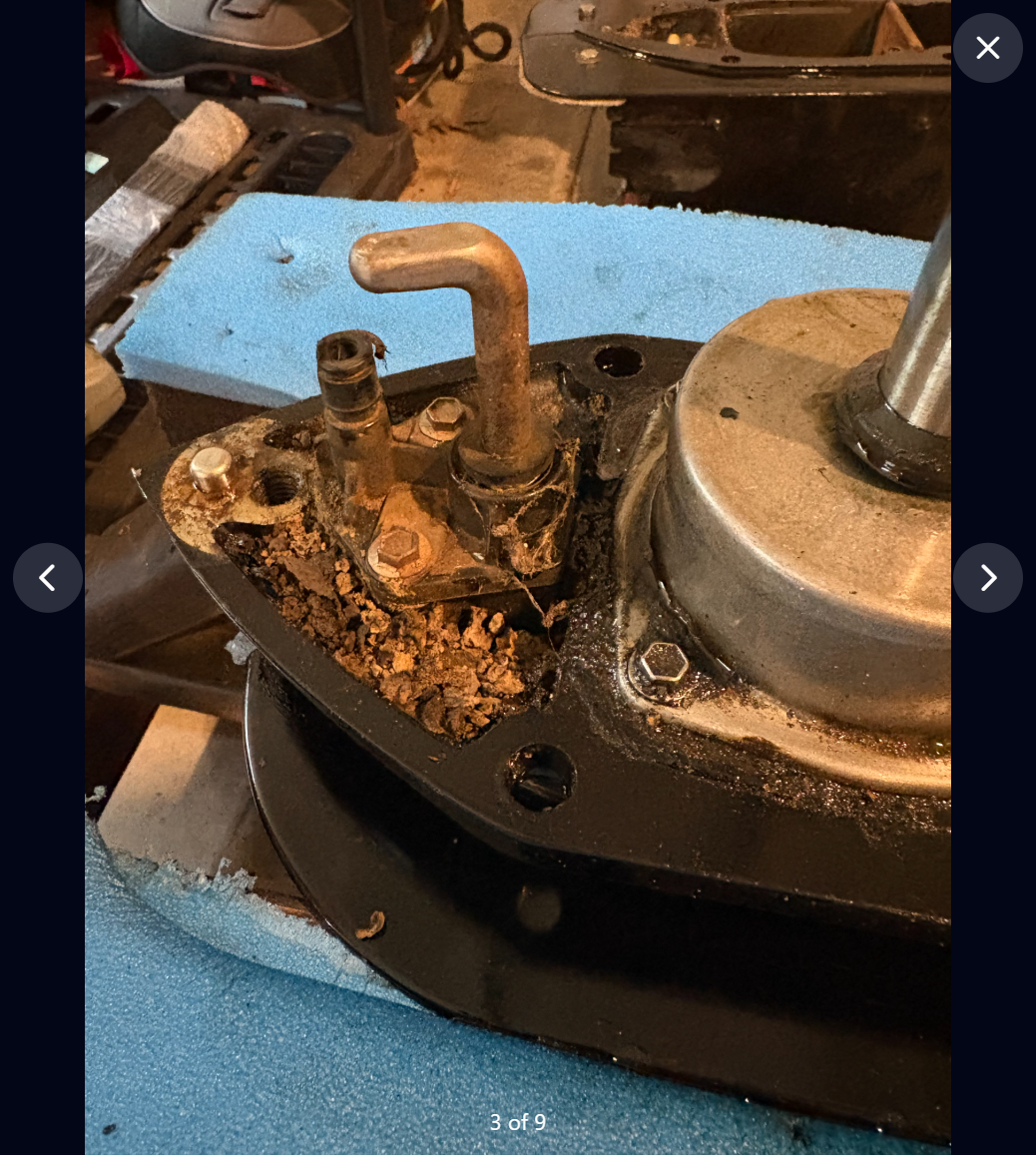 Full-screen project photo of the lower sterndrive in its initial state, before cleaning, labeled 3 of 9.